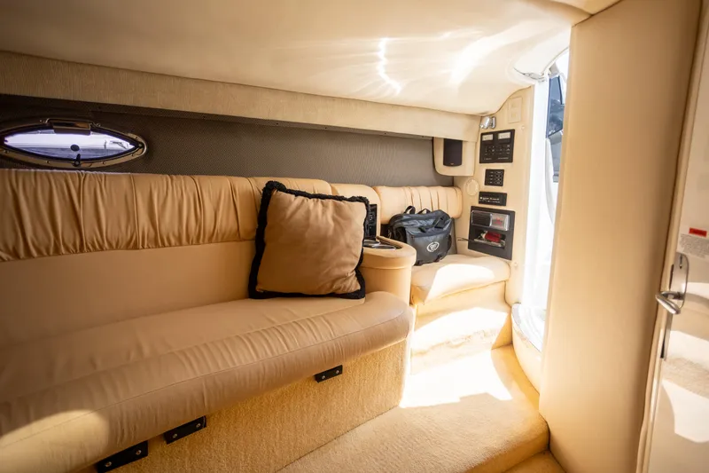 Slide: The Image of Luxurious interior of a 2005 Cobalt 343 boat with beige seating and modern amenities. - 22