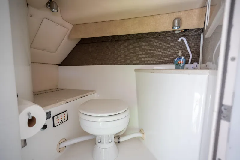Slide: The Image of Compact bathroom in 2005 Cobalt 343 boat with toilet, sink, and storage. - 23