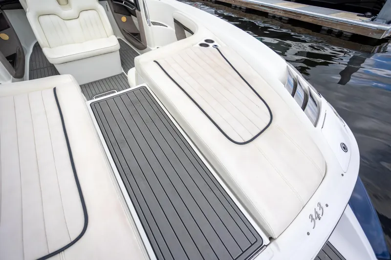 Slide: The Image of 2005 Cobalt 343 boat interior with white seating and sleek deck design. - 26