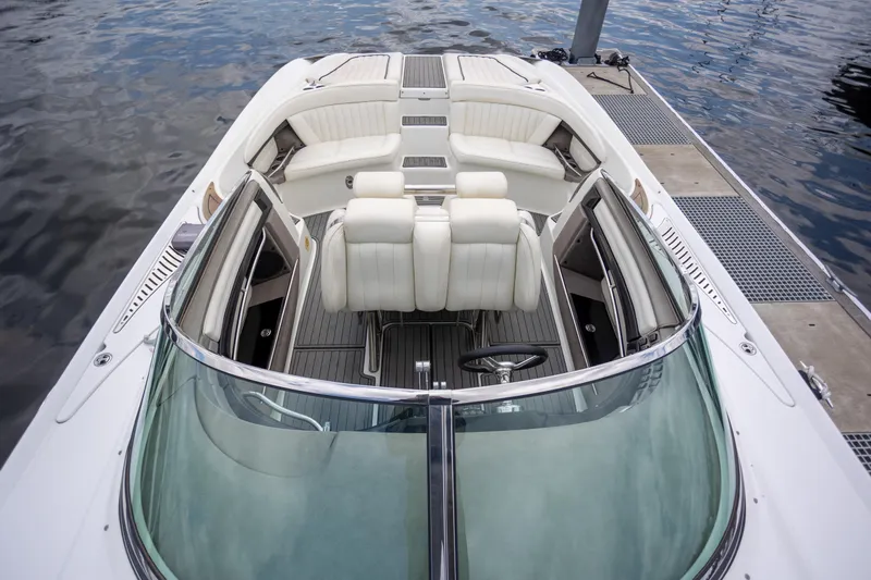 Slide: The Image of 2005 Cobalt 343 boat interior with white seating, docked by the water. - 30