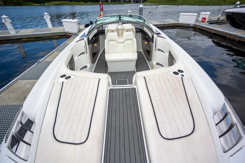 Slide: The Image of 2005 Cobalt 343 boat interior with white seating, docked by the water. - 4