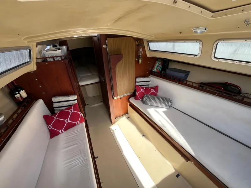 Slide: The Image of Interior of 1982 Catalina 27 sailboat with cozy seating and nautical decor. - 14