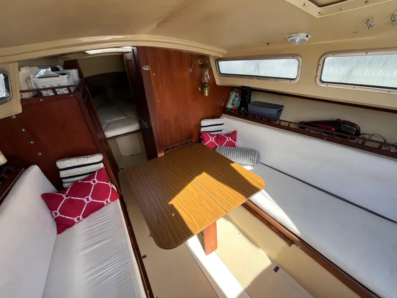 Slide: The Image of Interior of 1982 Catalina 27 sailboat with cozy seating and wooden table. - 15