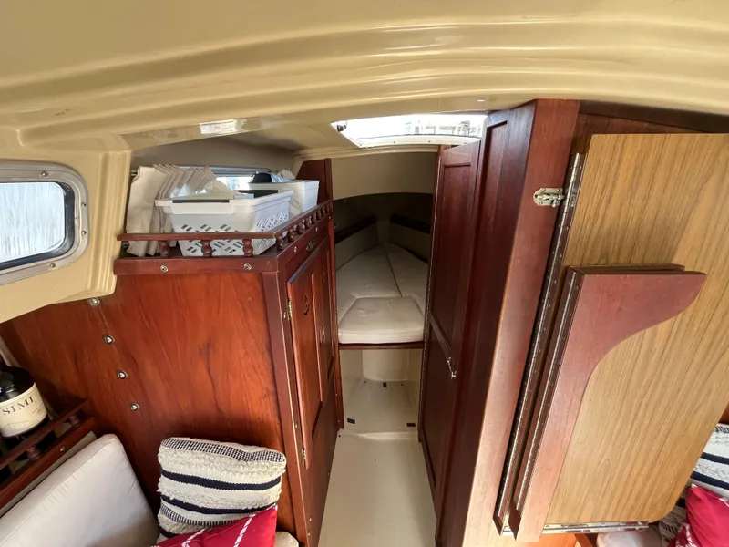 Slide: The Image of Interior of 1982 Catalina 27 sailboat with cozy cabin and wooden furnishings. - 19