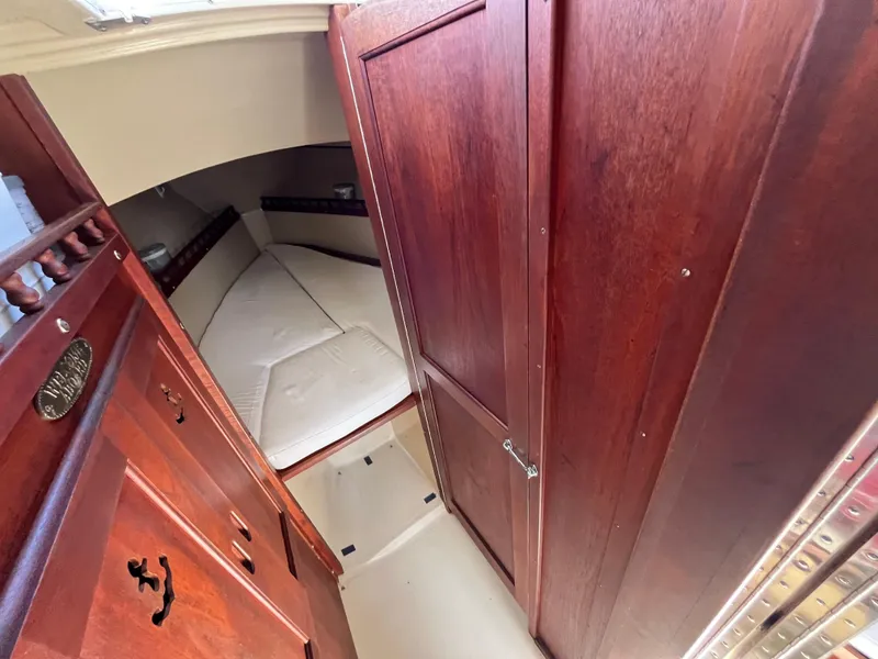 Slide: The Image of Interior of 1982 Catalina 27 sailboat with wooden cabinetry and cozy sleeping area. - 21