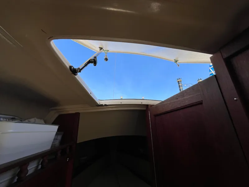 Slide: The Image of Interior view of 1982 Catalina 27 sailboat with open hatch and clear sky. - 23