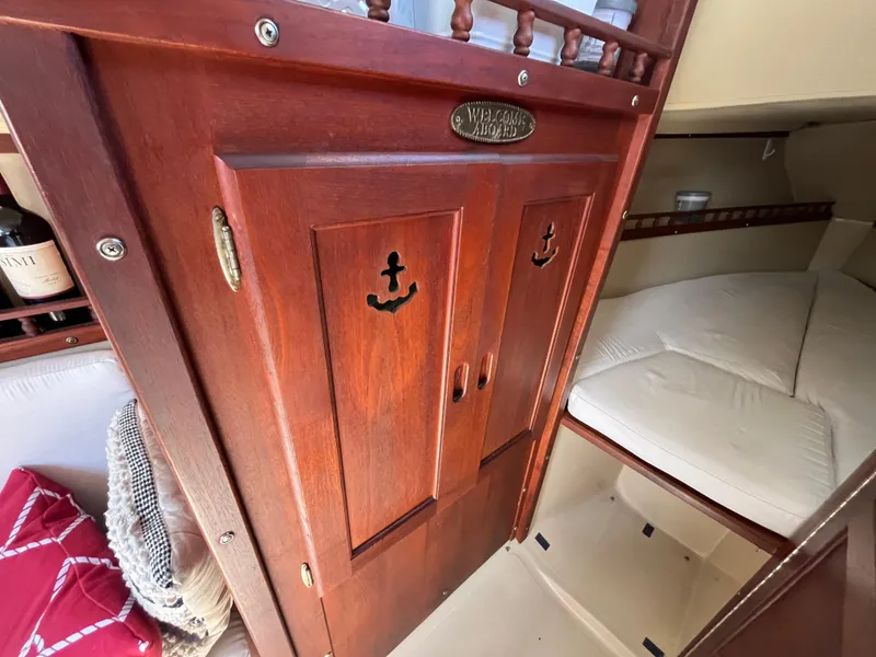 Slide: The Image of Interior of 1982 Catalina 27 sailboat with wooden cabinetry and cozy sleeping area. - 24