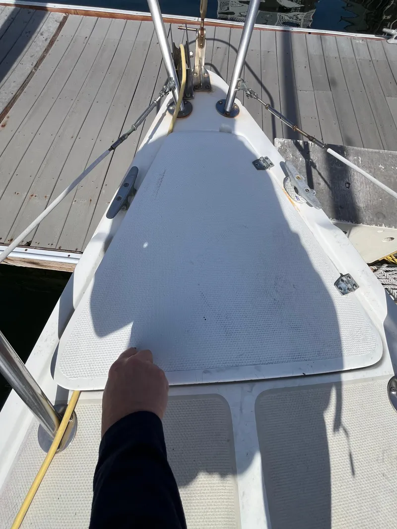 Slide: The Image of 1982 Catalina 27 sailboat deck with handrail and dock in view. - 5