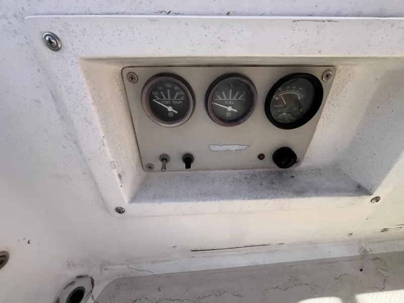 Slide: The Image of Dashboard gauges on a 1982 Catalina 27 sailboat, showing temperature and voltage indicators. - 9