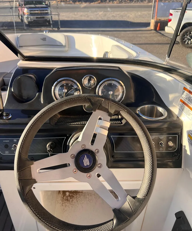 Slide: The Image of 2024 Bayliner VR40B boat dashboard with steering wheel and gauges. - 5