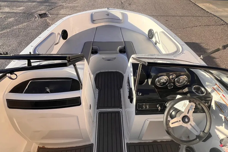 Slide: The Image of 2024 Bayliner VR40B boat interior with steering wheel and seating area. - 6