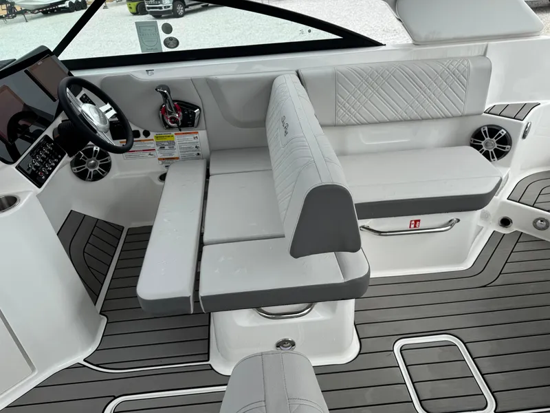 Slide: The Image of 2025 Sea Ray SDX 250 boat interior with sleek seating and modern dashboard. - 11