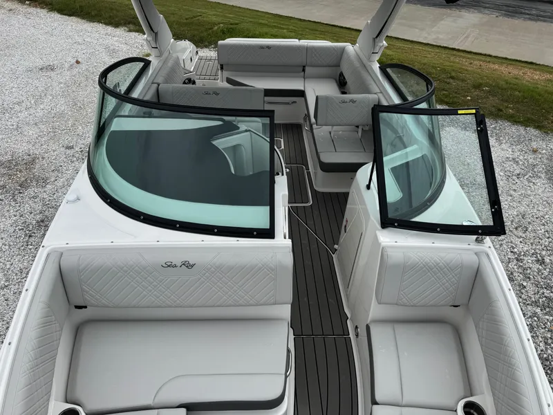 Slide: The Image of 2025 Sea Ray SDX 250 boat interior with white seating and open windshield. - 16