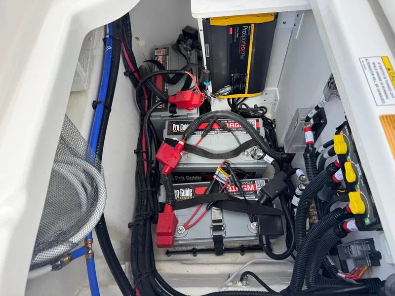 Slide: The Image of Electrical system of 2025 Sea Ray SDX 250 boat, featuring batteries and wiring. - 23