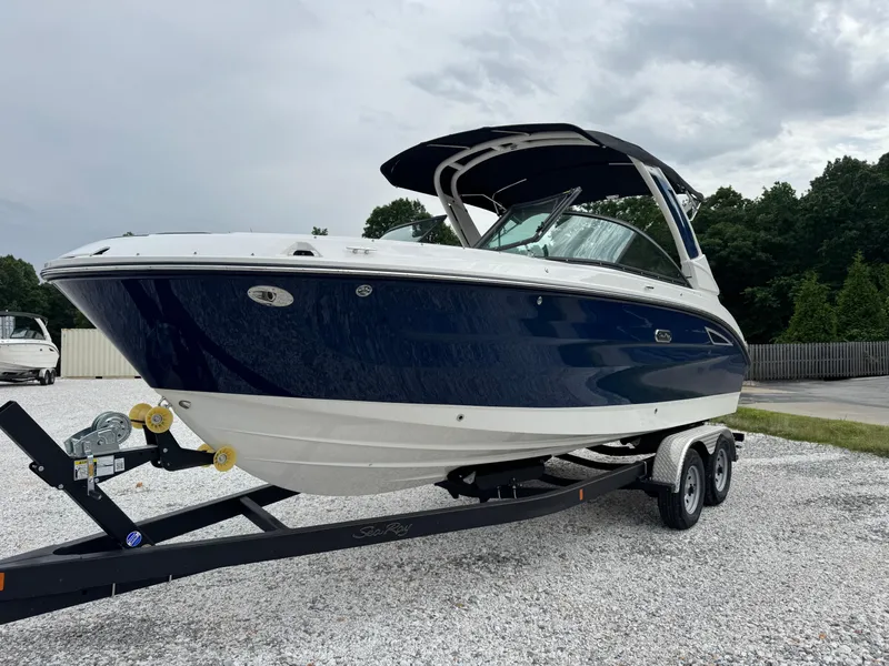 Slide: The Image of 2025 Sea Ray SDX 250 boat on trailer, blue and white design, parked outdoors. - 3