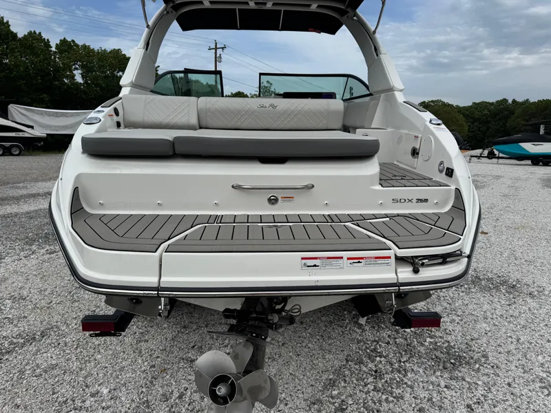 Slide: The Image of 2025 Sea Ray SDX 250 boat, rear view, showcasing deck and seating area. - 7