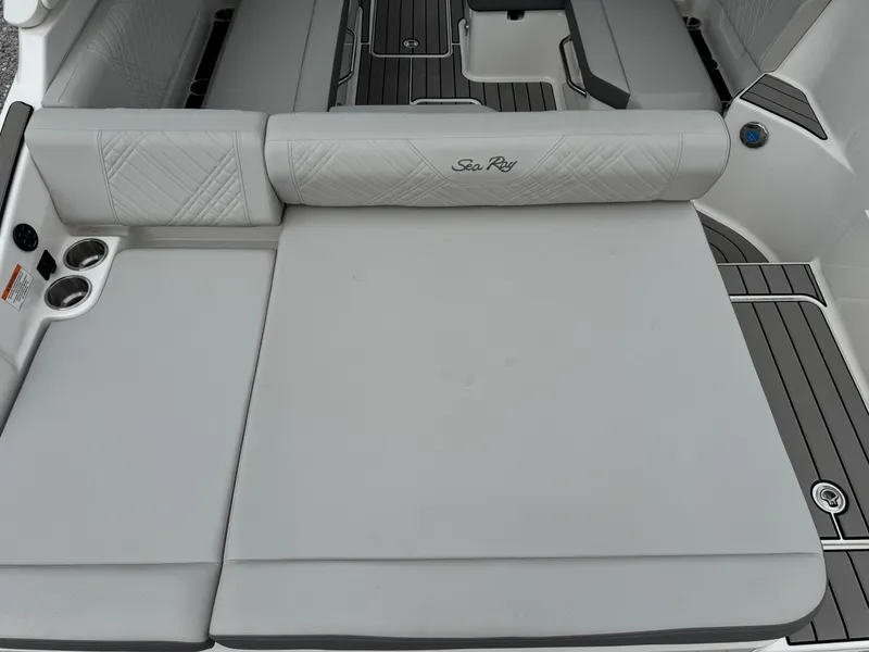 Slide: The Image of 2025 Sea Ray SDX 250 boat interior with gray cushioned seating and cup holders. - 8