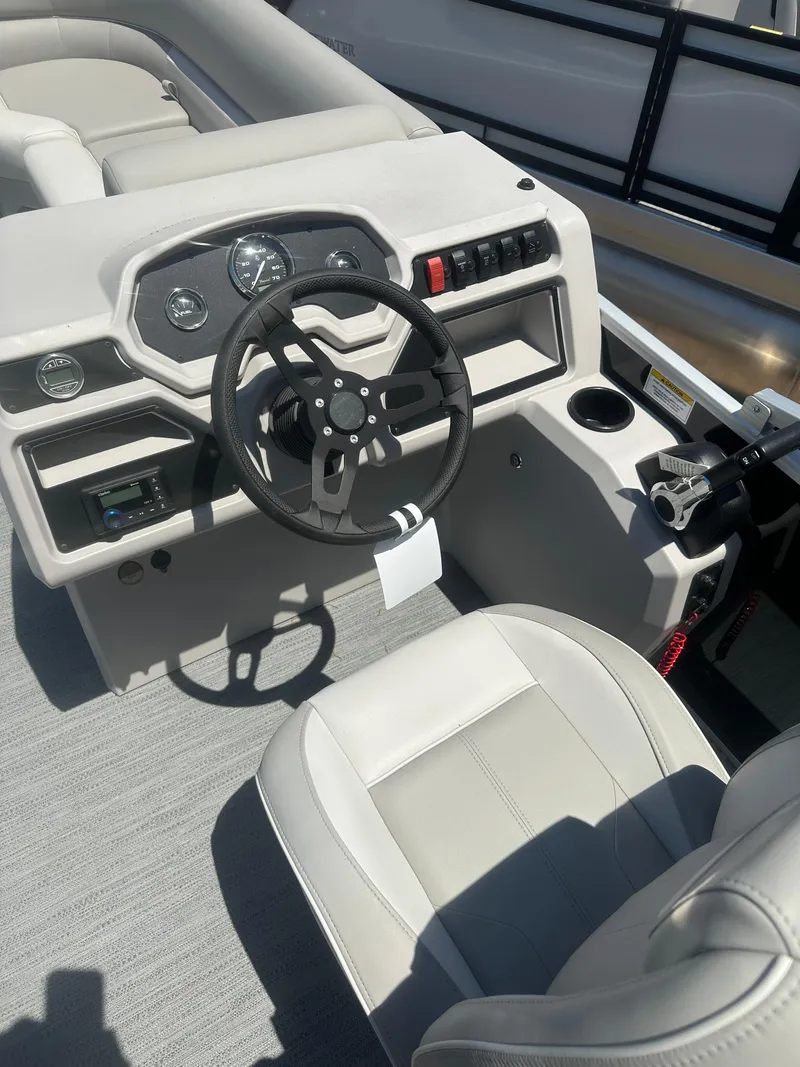 Slide: The Image of 2025 Godfrey 2086 CPX Sport-Tube Tritoon boat interior with steering wheel and dashboard. - 13