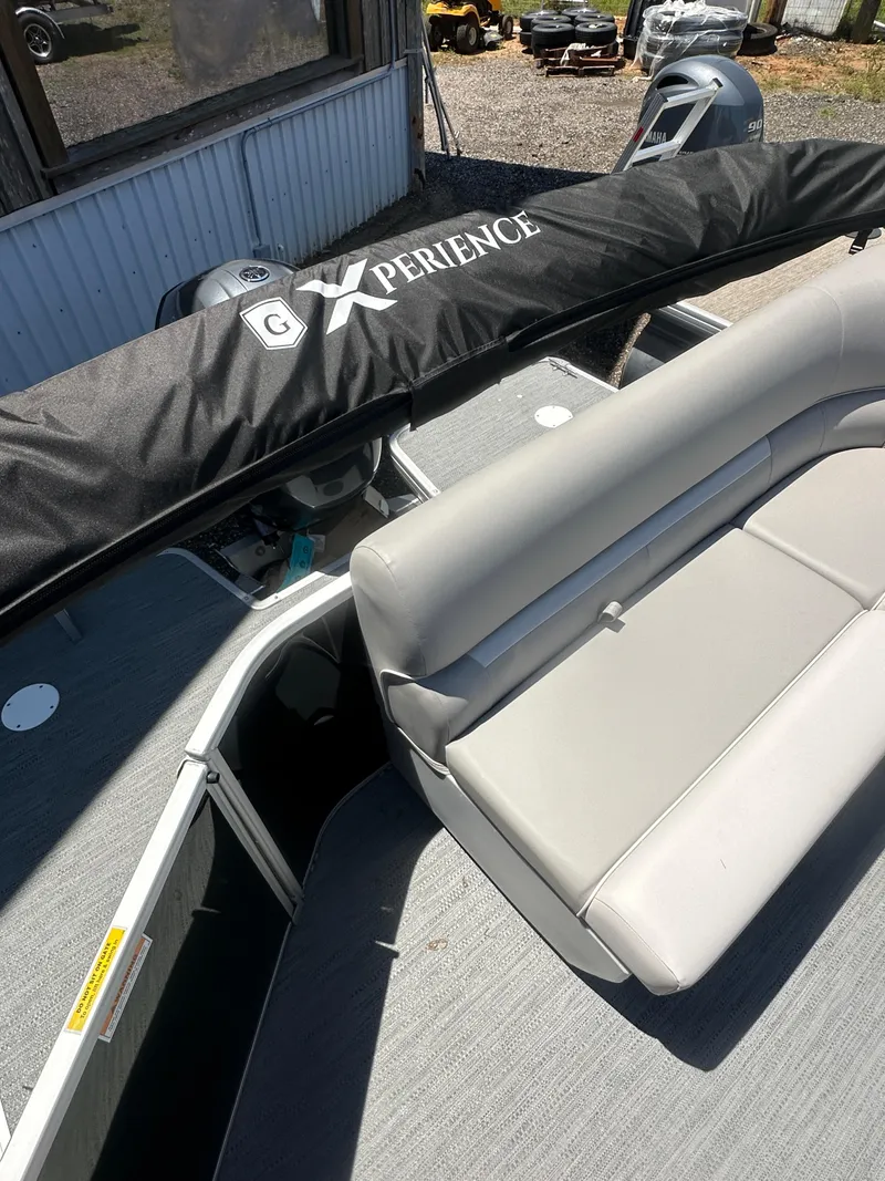 Slide: The Image of 2025 Godfrey 2086 CPX Sport-Tube Tritoon with gray seating and covered console. - 14