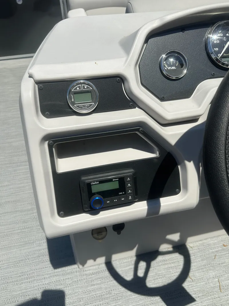 Slide: The Image of Control panel of 2025 Godfrey 2086 CPX Sport-Tube Tritoon boat, featuring gauges and audio system. - 15