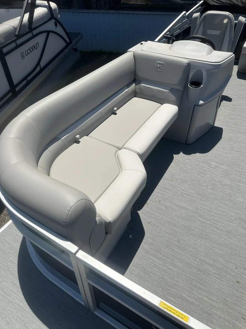 Slide: The Image of 2025 Godfrey 2086 CPX Sport-Tube Tritoon with gray seating and modern design. - 9