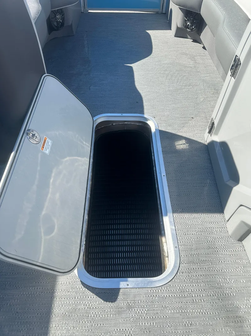 Slide: The Image of Open storage compartment on 2025 Godfrey Monaco 235 DFL Tritoon boat. - 16