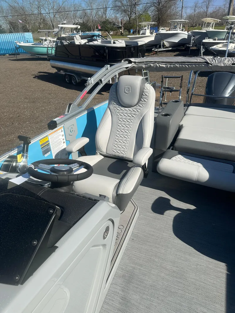 Slide: The Image of 2025 Godfrey Monaco 235 DFL Tritoon interior with captain's chair and steering wheel. - 19