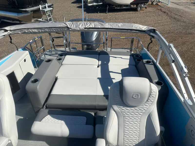 Slide: The Image of 2025 Godfrey Monaco 235 DFL Tritoon interior with plush seating and cup holders. - 20