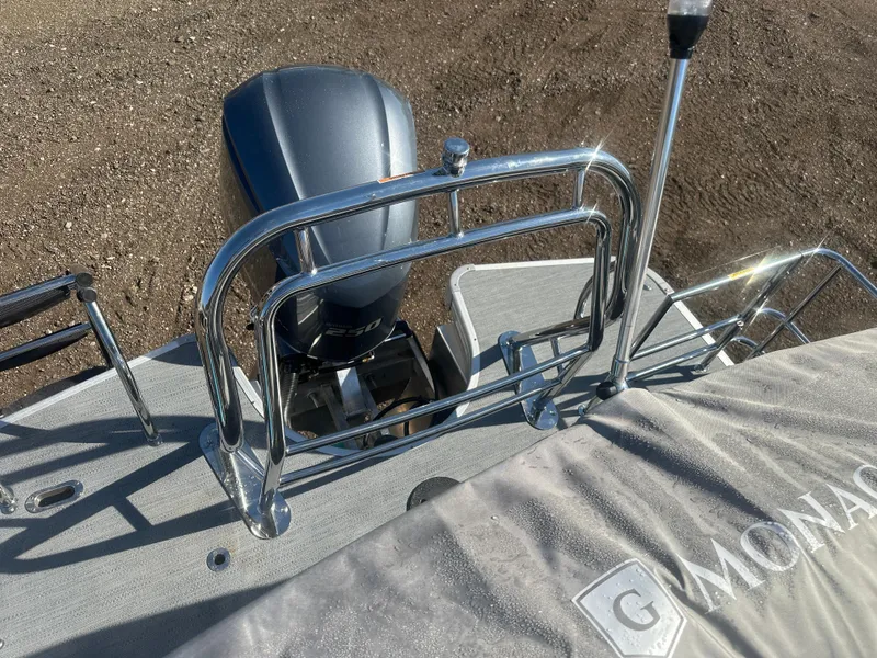 Slide: The Image of 2025 Godfrey Monaco 235 DFL Tritoon boat with engine and railing details. - 26