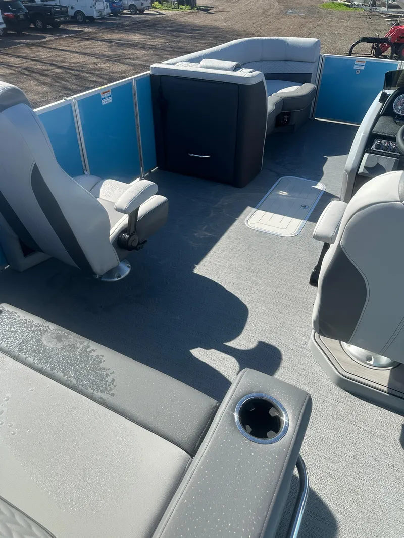 Slide: The Image of 2025 Godfrey Monaco 235 DFL Tritoon interior with seating and steering console. - 28