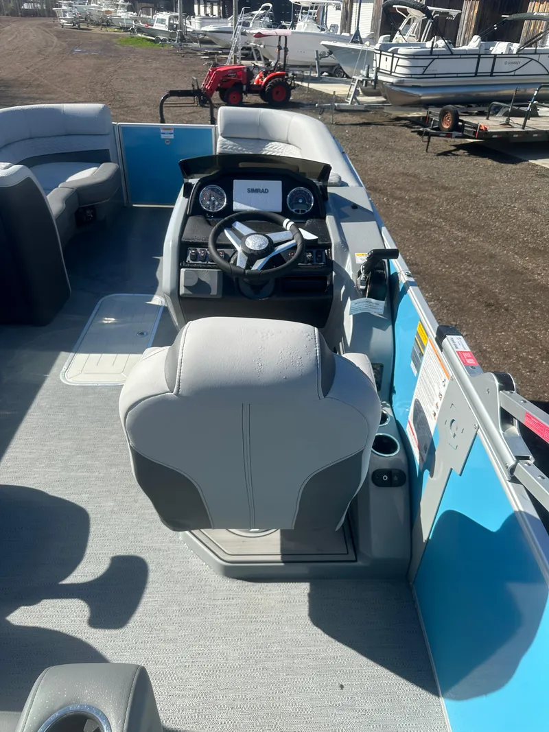 Slide: The Image of 2025 Godfrey Monaco 235 DFL Tritoon interior with steering console and seating. - 29