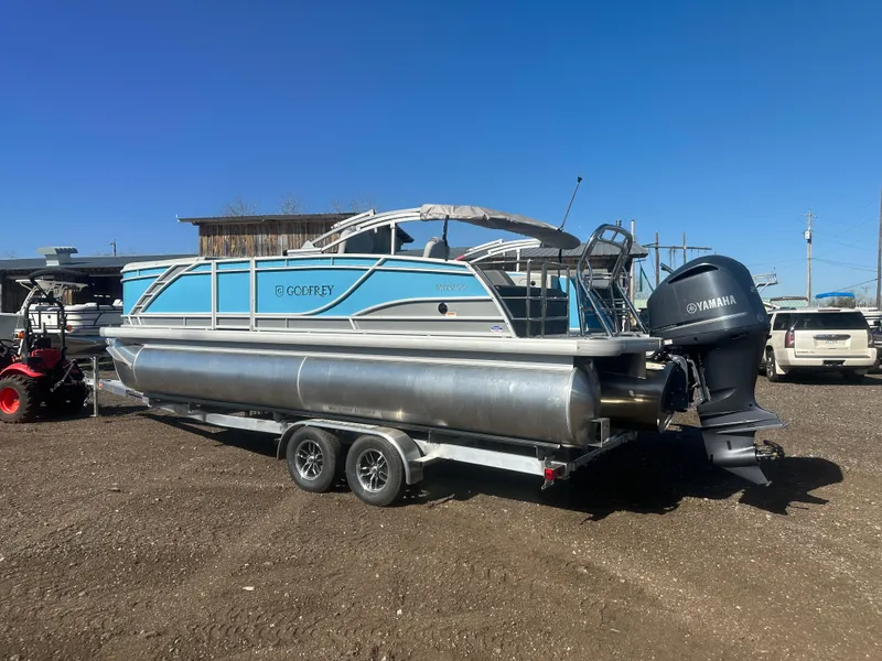 Slide: The Image of 2025 Godfrey Monaco 235 DFL Tritoon on trailer, featuring Yamaha outboard motor. - 3