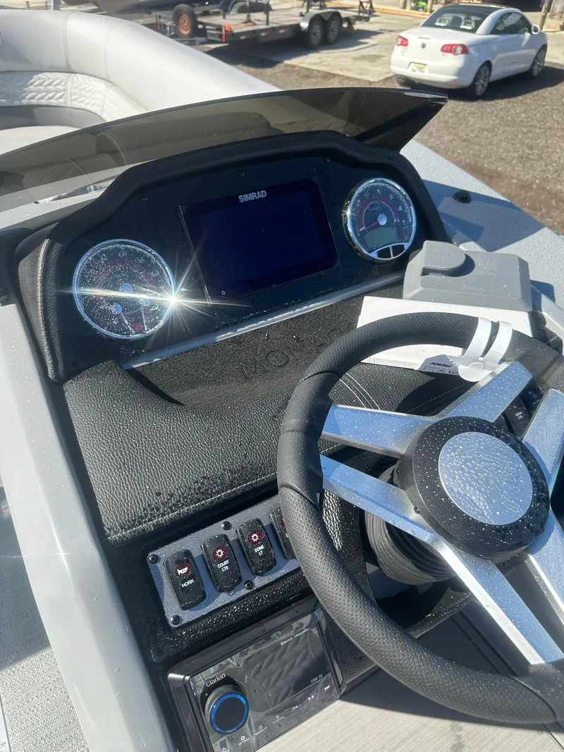 Slide: The Image of 2025 Godfrey Monaco 235 DFL Tritoon dashboard with steering wheel and controls. - 31