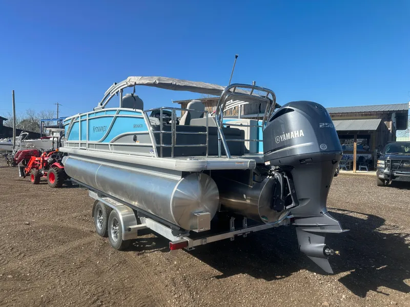 Slide: The Image of 2025 Godfrey Monaco 235 DFL Tritoon with Yamaha engine on trailer, parked outdoors. - 4