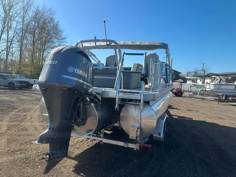 Slide: The Image of 2025 Godfrey Monaco 235 DFL Tritoon with Yamaha engine, parked outdoors. - 5