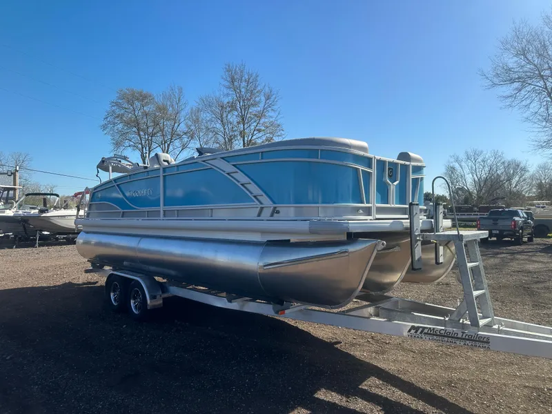 Slide: The Image of 2025 Godfrey Monaco 235 DFL Tritoon on trailer, parked outdoors. - 9