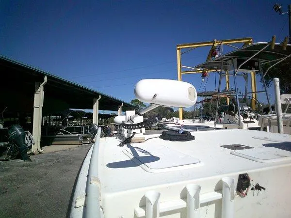 Slide: The Image of 2018 Carolina Skiff 198 DLX boat docked under clear blue sky. - 3