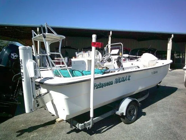 Slide: The Image of 2018 Carolina Skiff 198 DLX boat on trailer, parked outdoors. - 7