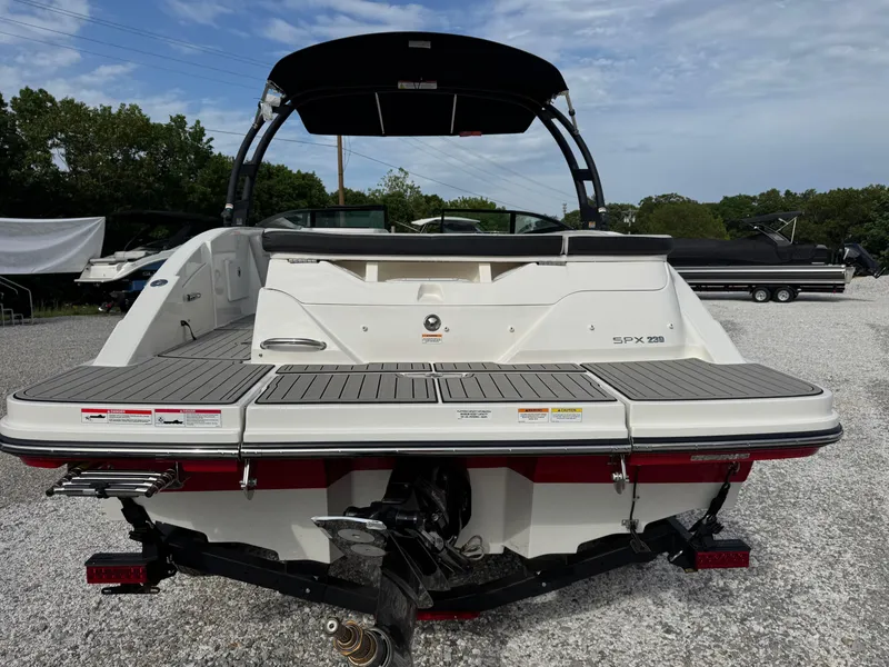 Slide: The Image of 2025 Sea Ray SPX 230 boat rear view, showcasing swim platform and outboard motor. - 4