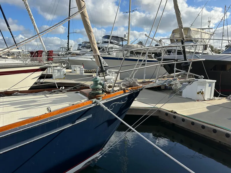 Slide: The Image of 1985 Shannon 43 Classic Cutter docked in a marina, surrounded by other boats. - 10