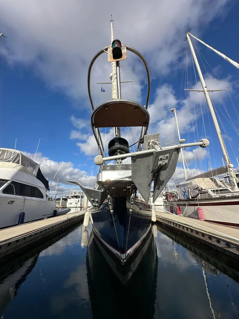 Slide: The Image of 1985 Shannon 43 Classic Cutter docked at marina under blue sky. - 13
