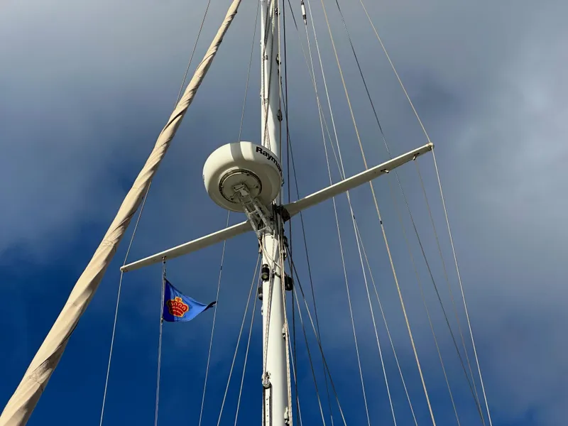 Slide: The Image of Mast of 1985 Shannon 43 Classic Cutter sailboat against a cloudy sky. - 15