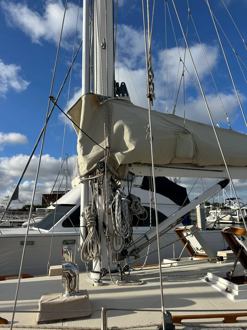 Slide: The Image of 1985 Shannon 43 Classic Cutter sailboat with rigging, docked under a blue sky. - 17