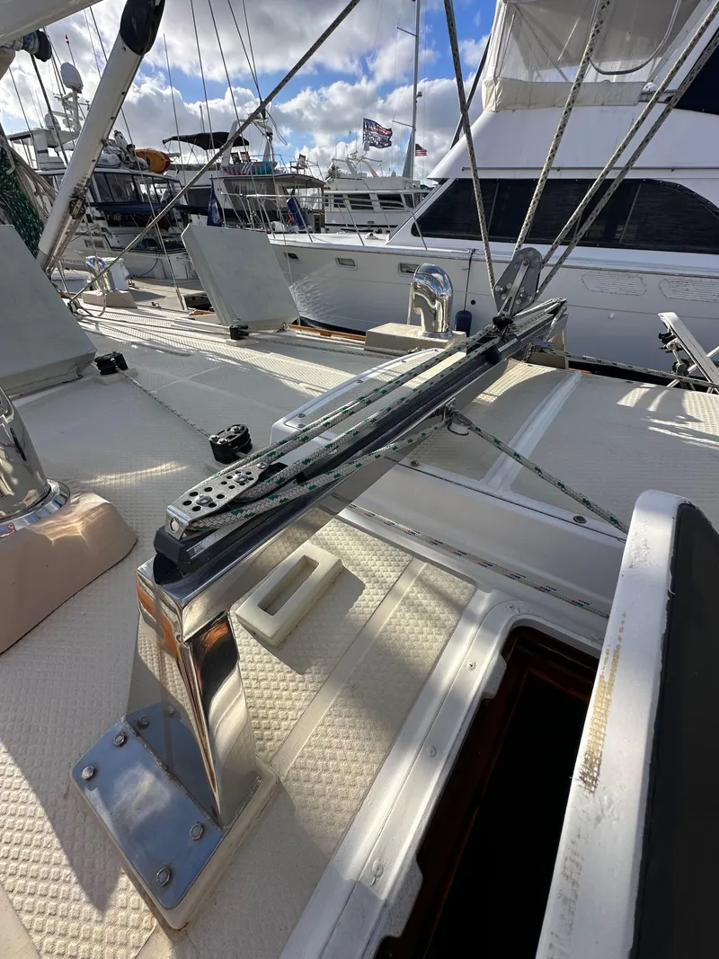 Slide: The Image of 1985 Shannon 43 Classic Cutter deck with rigging and winches under a blue sky. - 24