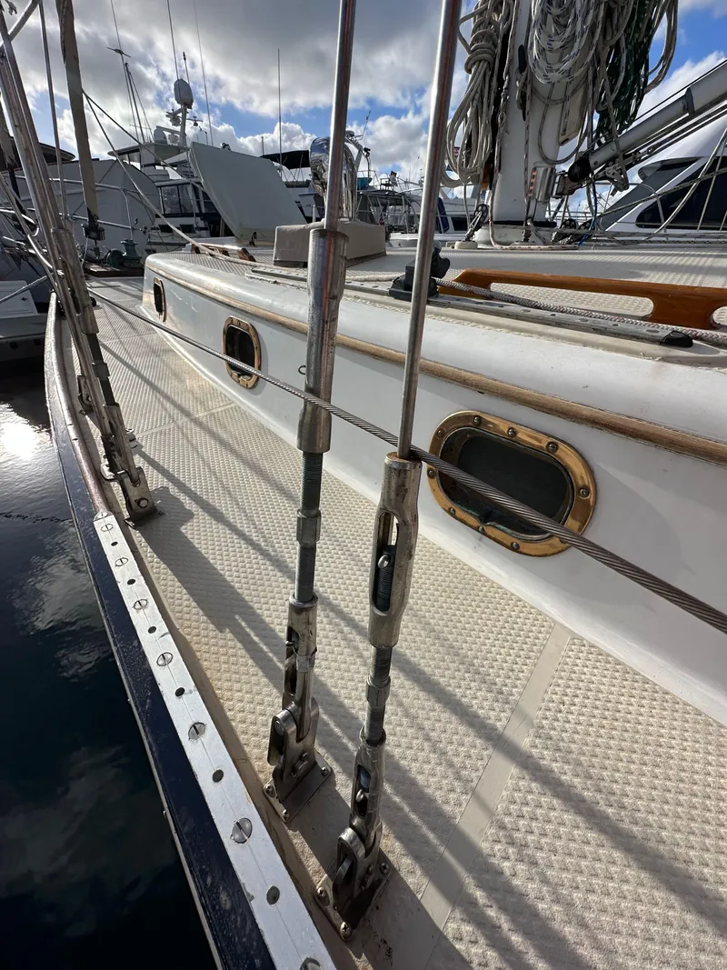 Slide: The Image of 1985 Shannon 43 Classic Cutter sailboat deck with rigging and portholes in marina. - 27