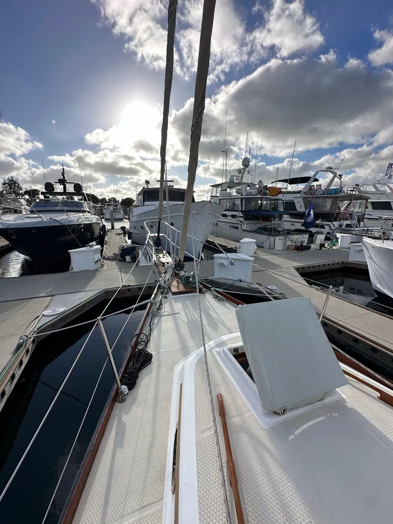 Slide: The Image of 1985 Shannon 43 Classic Cutter docked at marina under cloudy sky. - 28