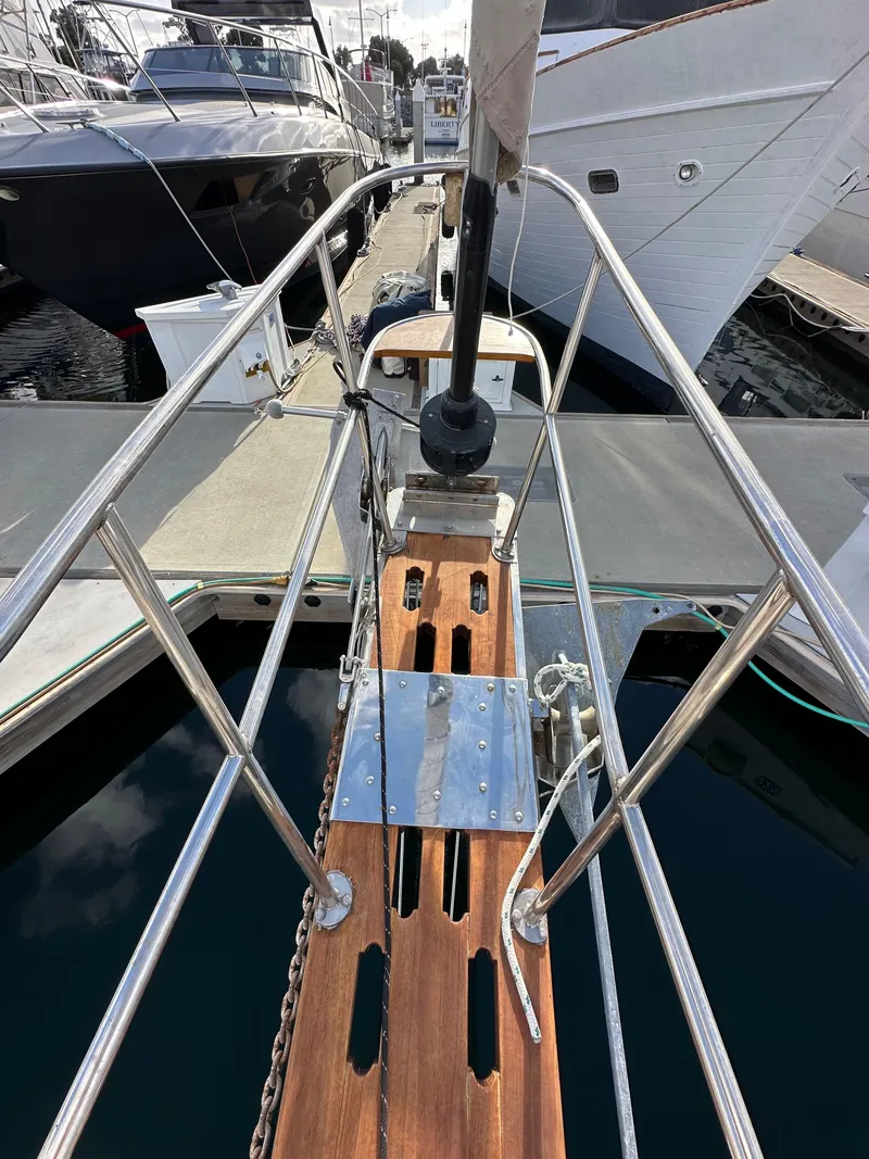 Slide: The Image of 1985 Shannon 43 Classic Cutter, wooden deck, docked at marina, surrounded by other boats. - 30
