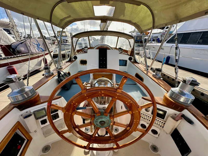 Slide: The Image of Cockpit of 1985 Shannon 43 Classic Cutter with wooden wheel and nautical instruments. - 40