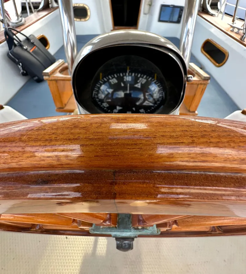 Slide: The Image of Wooden helm and compass on 1985 Shannon 43 Classic Cutter sailboat. - 43