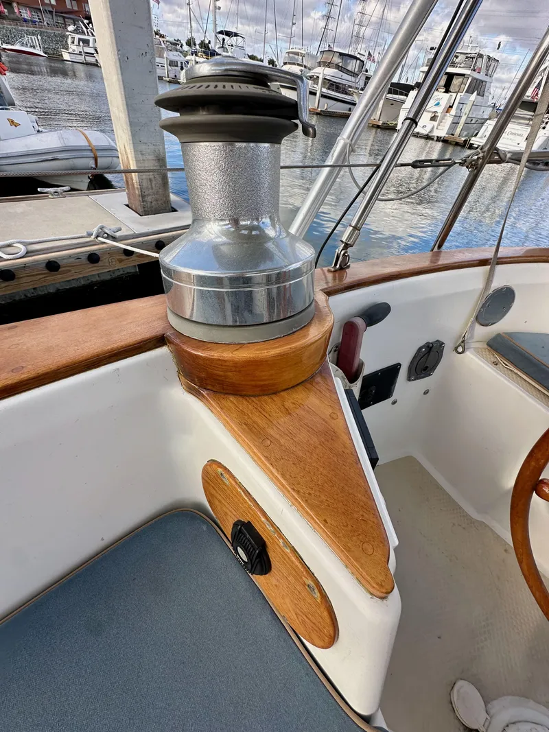Slide: The Image of 1985 Shannon 43 Classic Cutter sailboat cockpit with winch, docked in marina. - 45